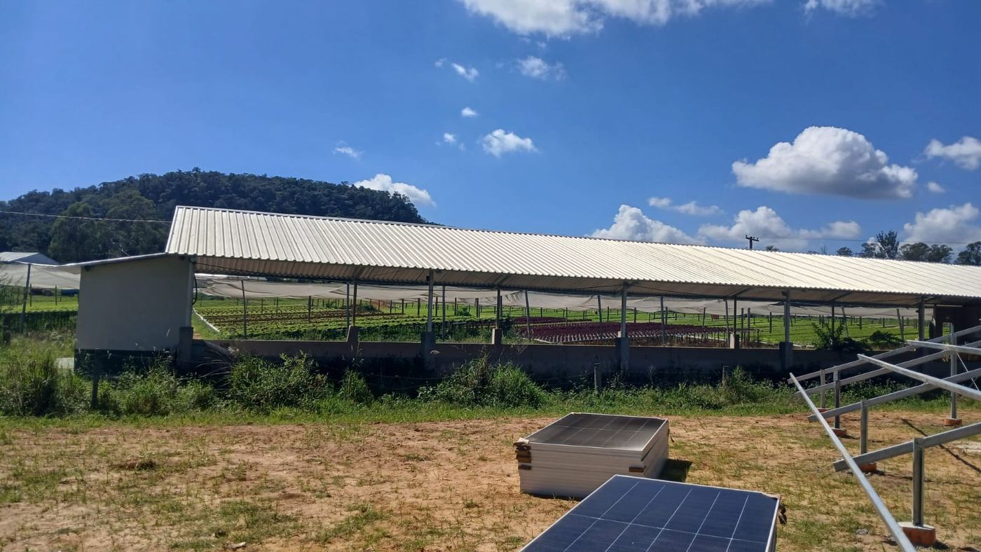 Usina em solo instalada ao lado de galpão rural